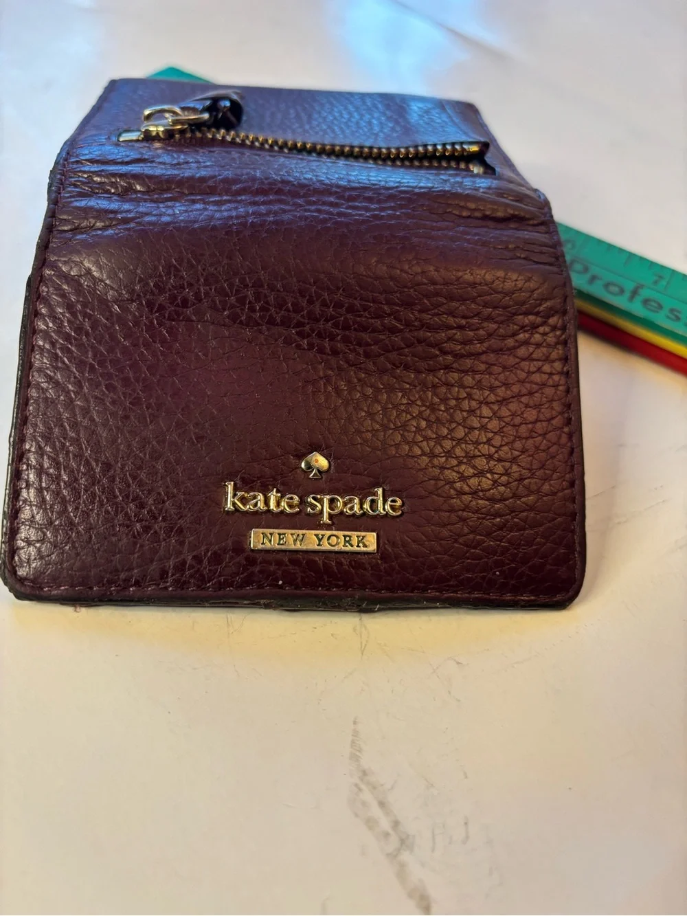 kate spade plum pebbled leather trifold wallet with gold logo